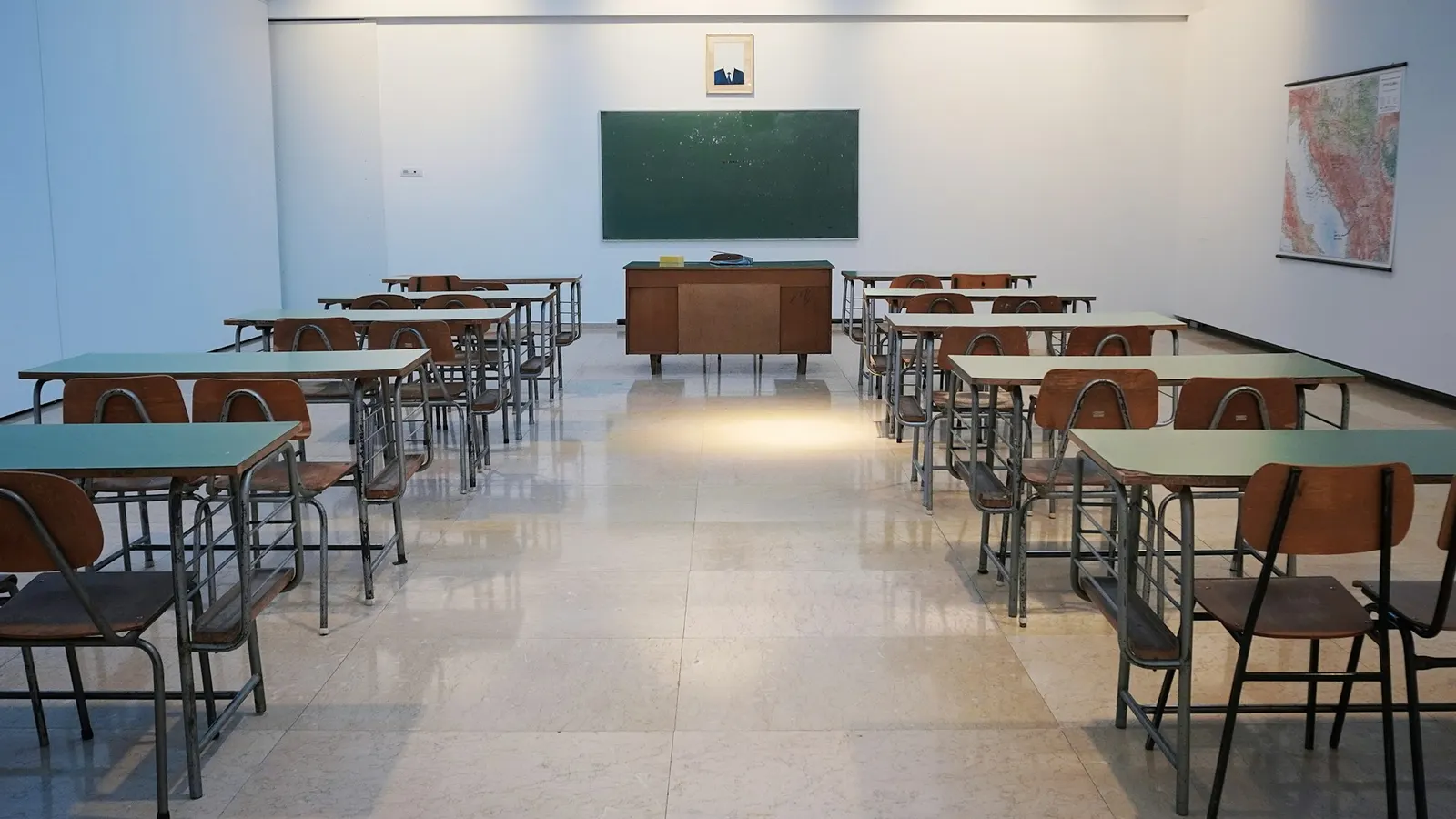Leeres Klassenzimmer mit Tischreihen und Tafel